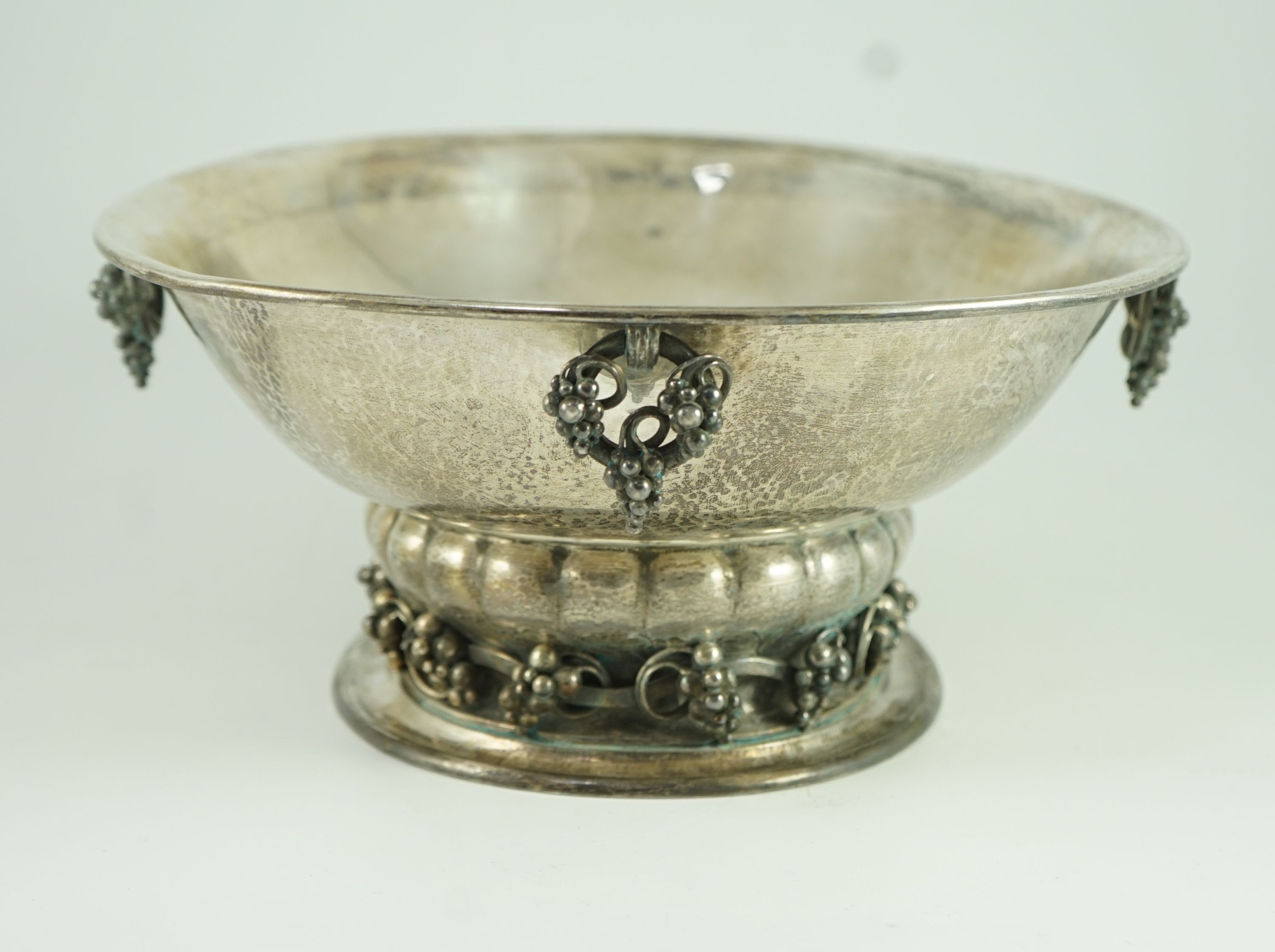 A good George V Georg Jensen planished silver Grape pattern oval pedestal fruit bowl, design no. 296